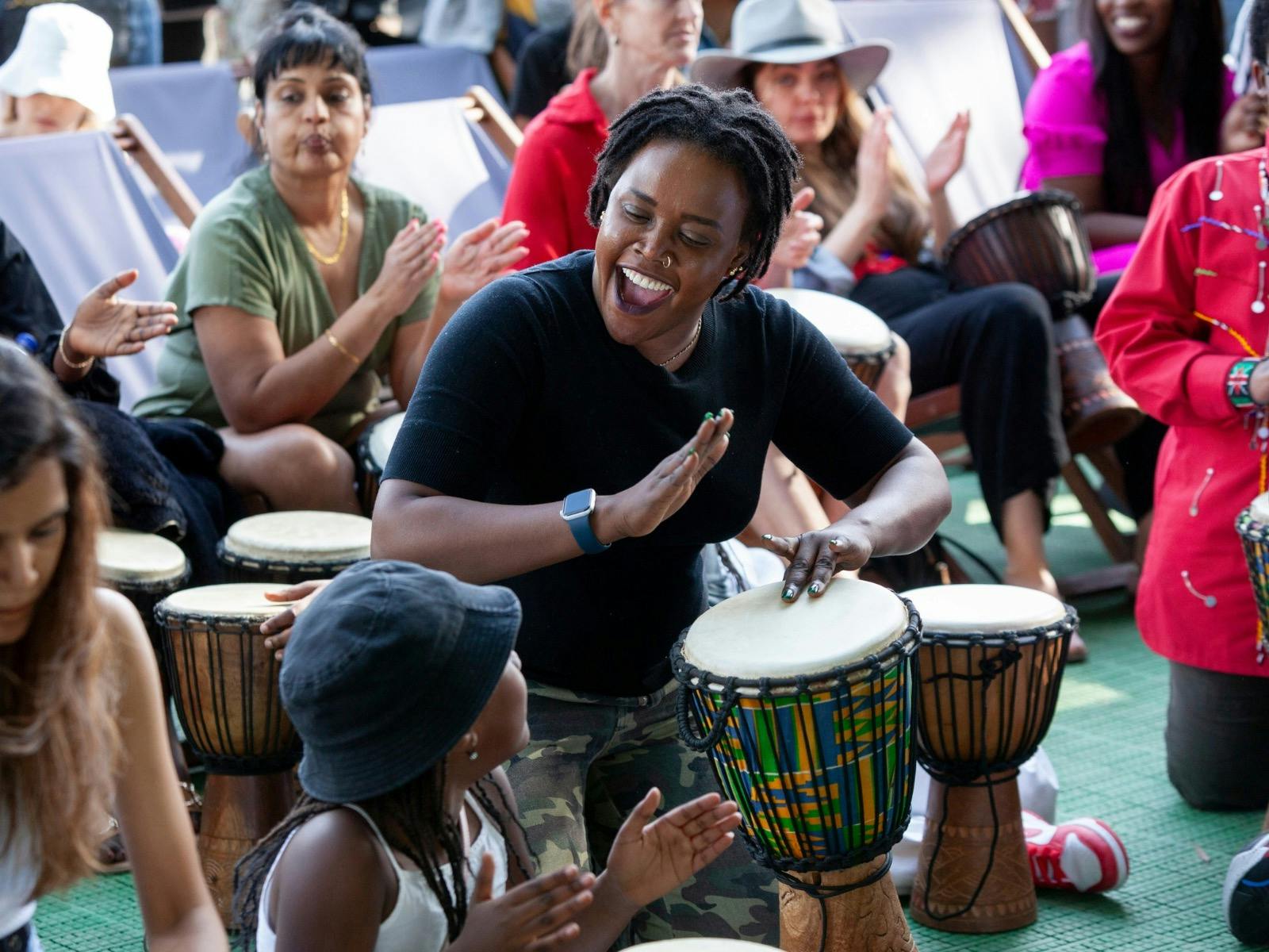 Female playing the African drums