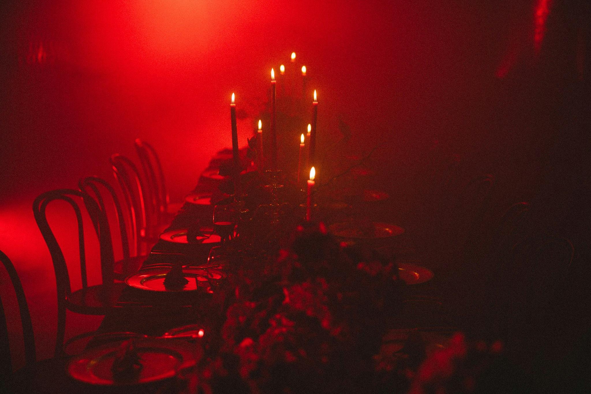 Close up of banquet table bathed in red light