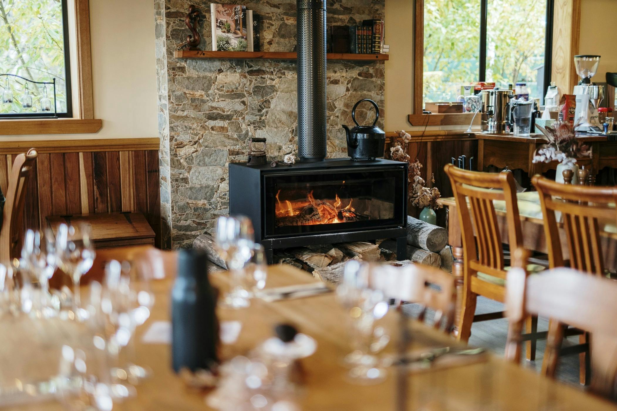 A set dining table in front of a fireplace