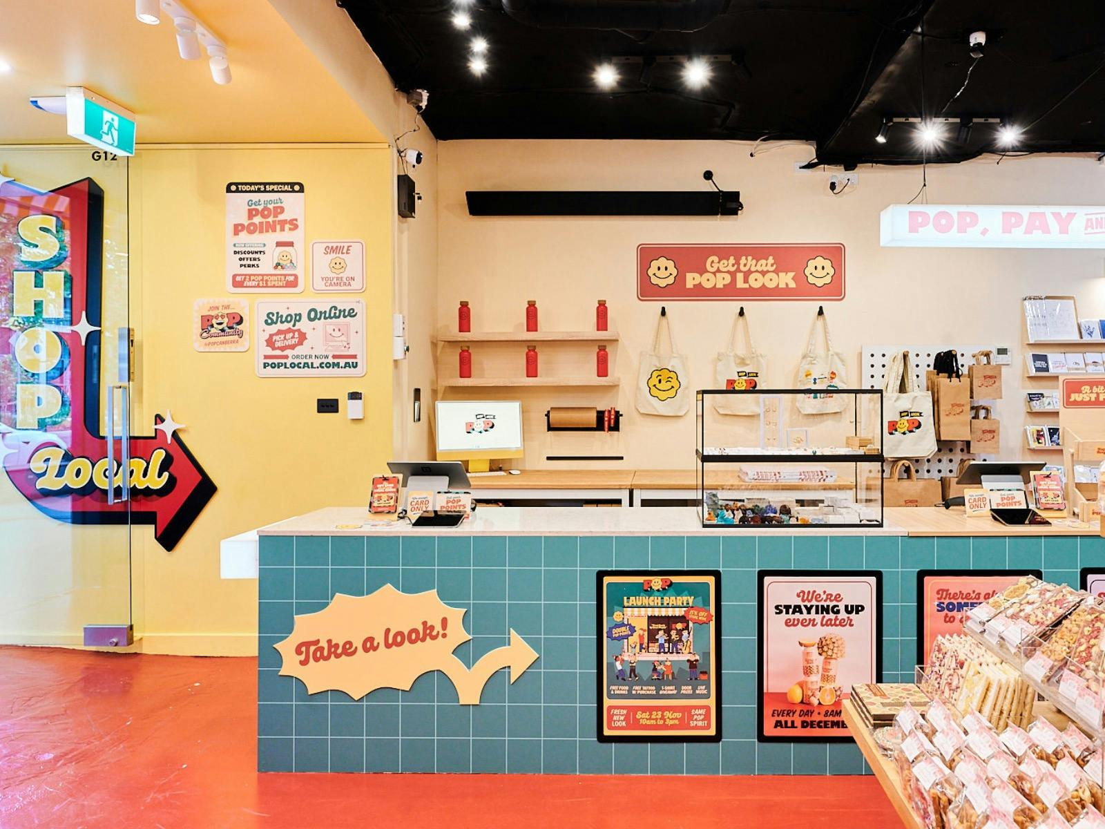 A bright and inviting interior of POP Canberra, featuring a checkout counter, merchandise.