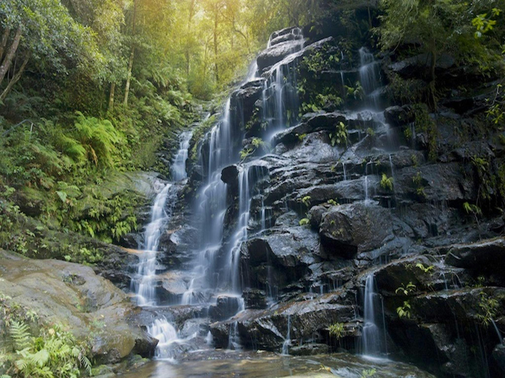 Water cascades over rock ledges at Empress Falls at the end of Empress Canyon in Blue Mountains