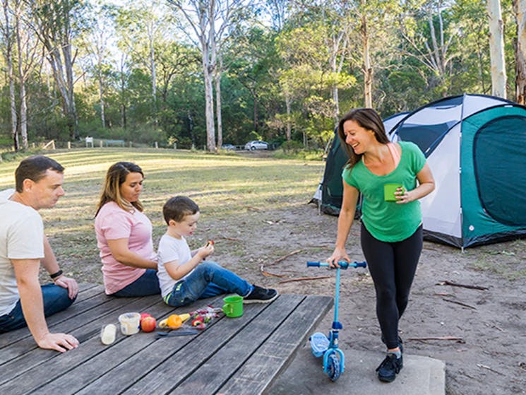 Family eating a picnic lunch in the Appletree Flat section of Euroka campground. Photo: OEH/Simone