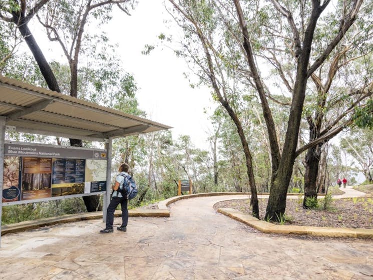 A visitor at the information shelter at Evans lookout in the Blackheath area of Blue Mountains