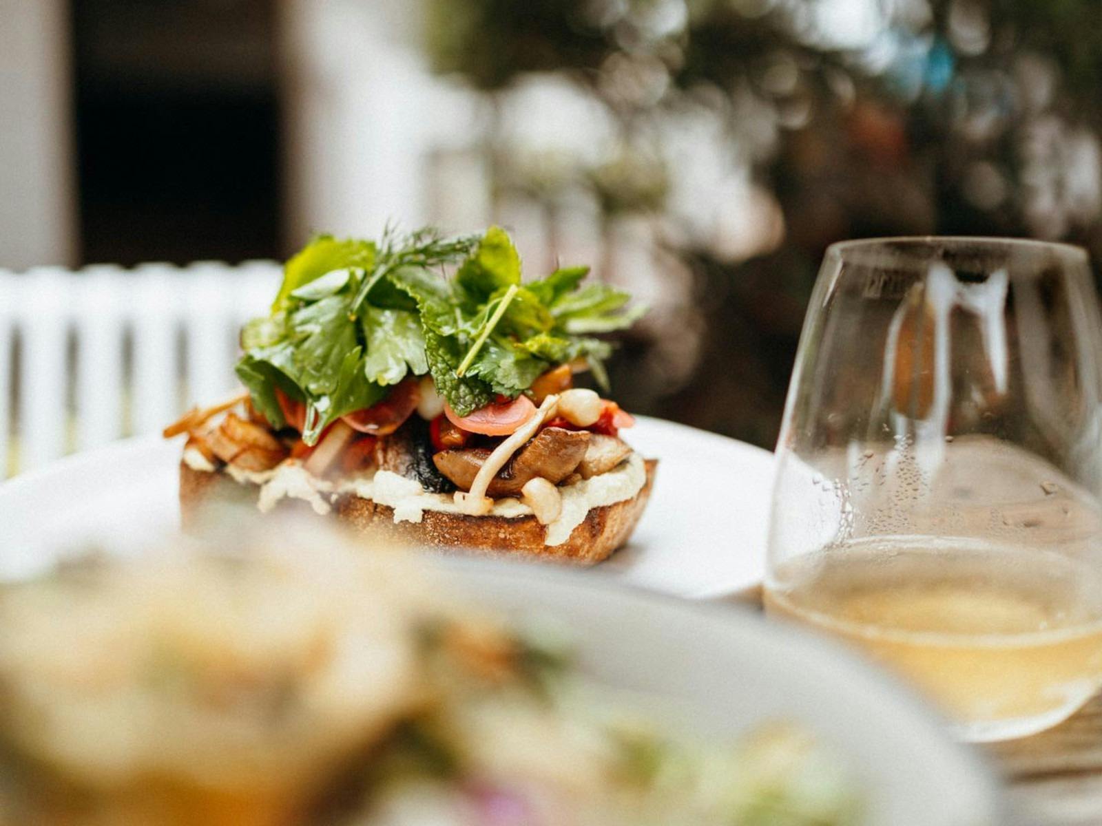 Delicious lunch stacked with fresh herbs. and glass of drink
