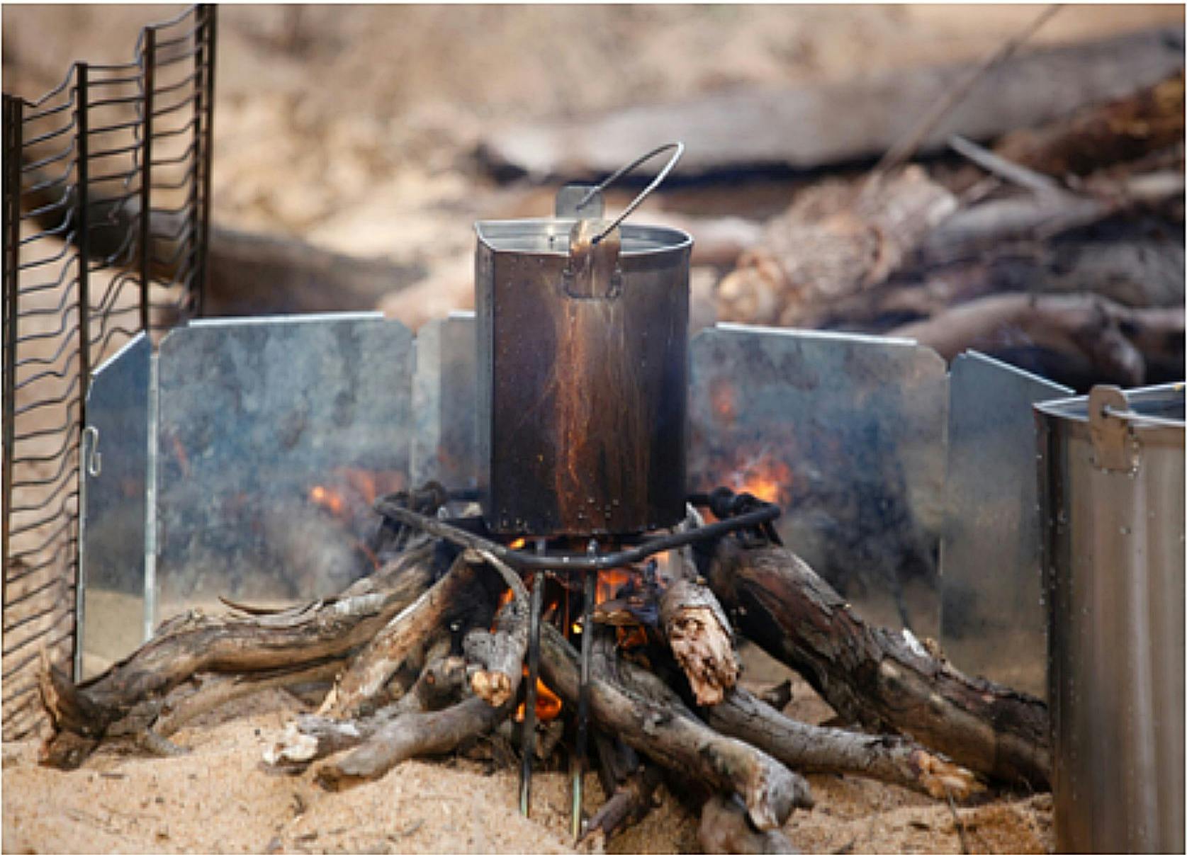 A Pack Billy Can, with a flat side, on a fire to make Billy Tea_ Wild River Explorer Walking Trek