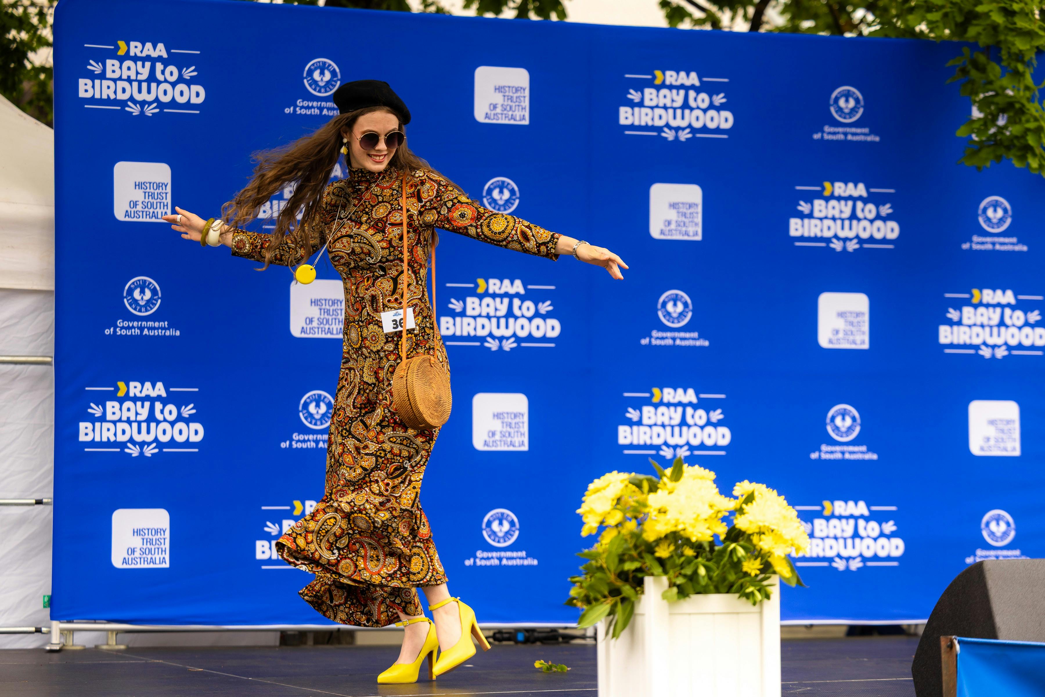 Women in 70s clothing dancing on stage