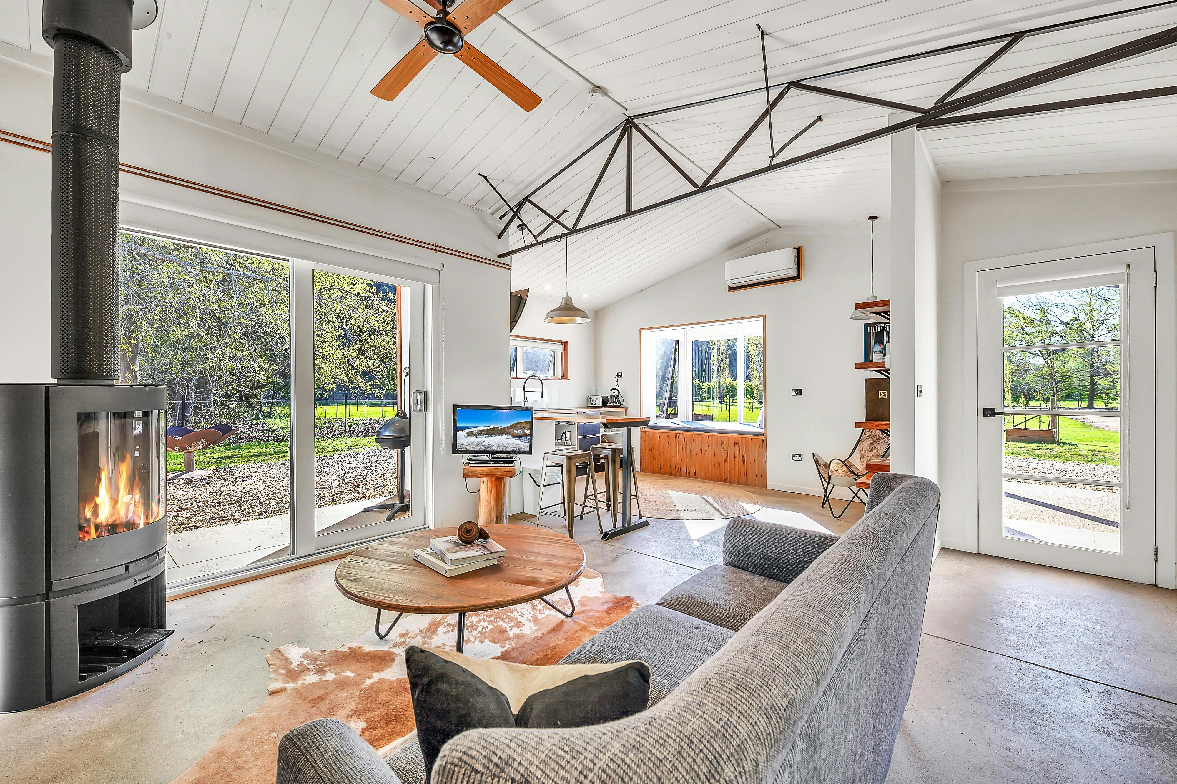 Lounge area with couch, tea table, fireplace and television