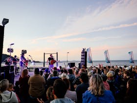 Music festival on the beach at sunset