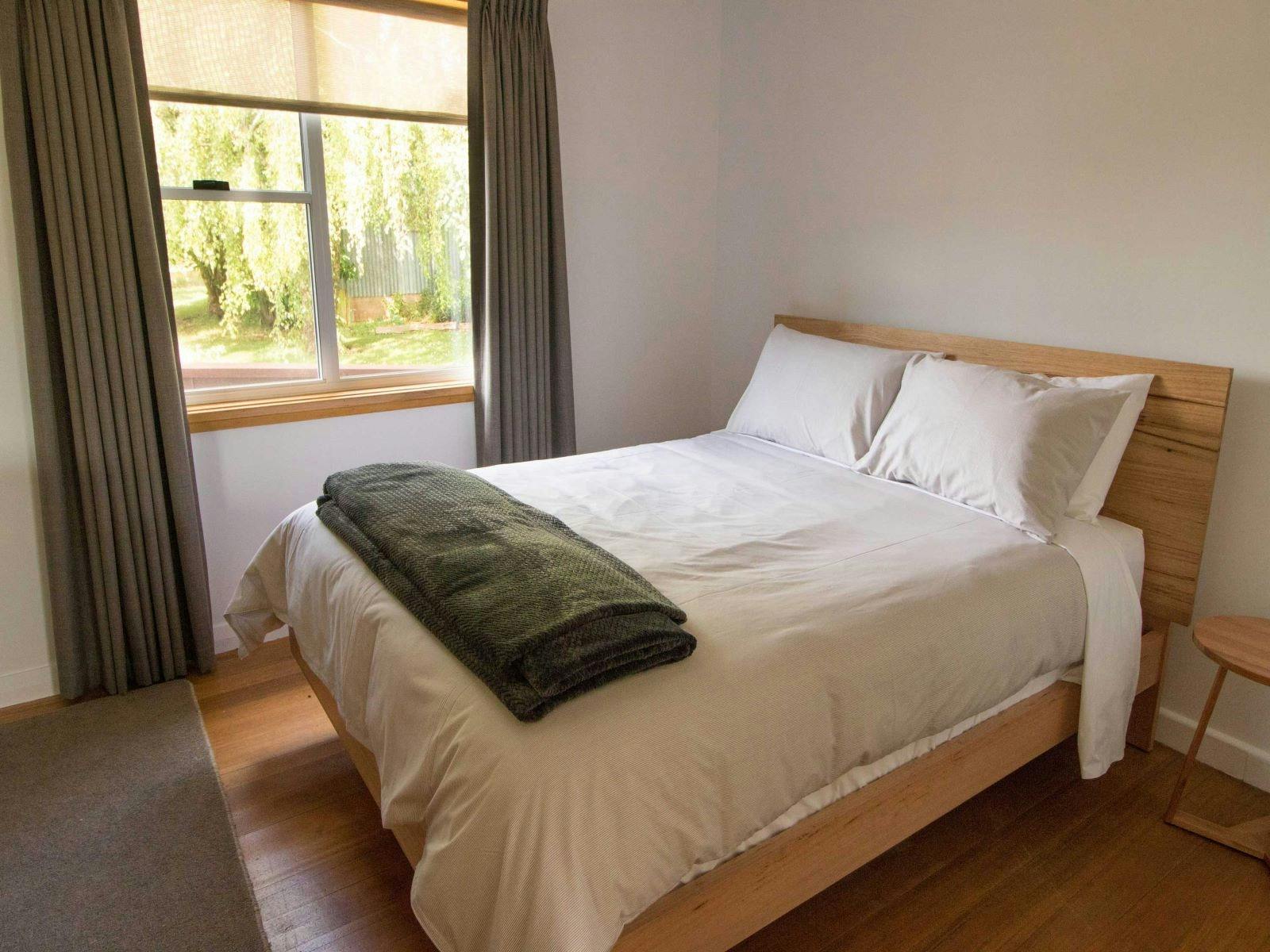 Bedroom with queen bed and window