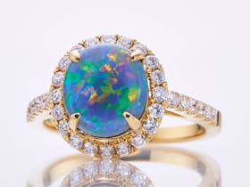 Lightning Ridge, solid black opal ring set with diamonds in 18ct yellow gold.