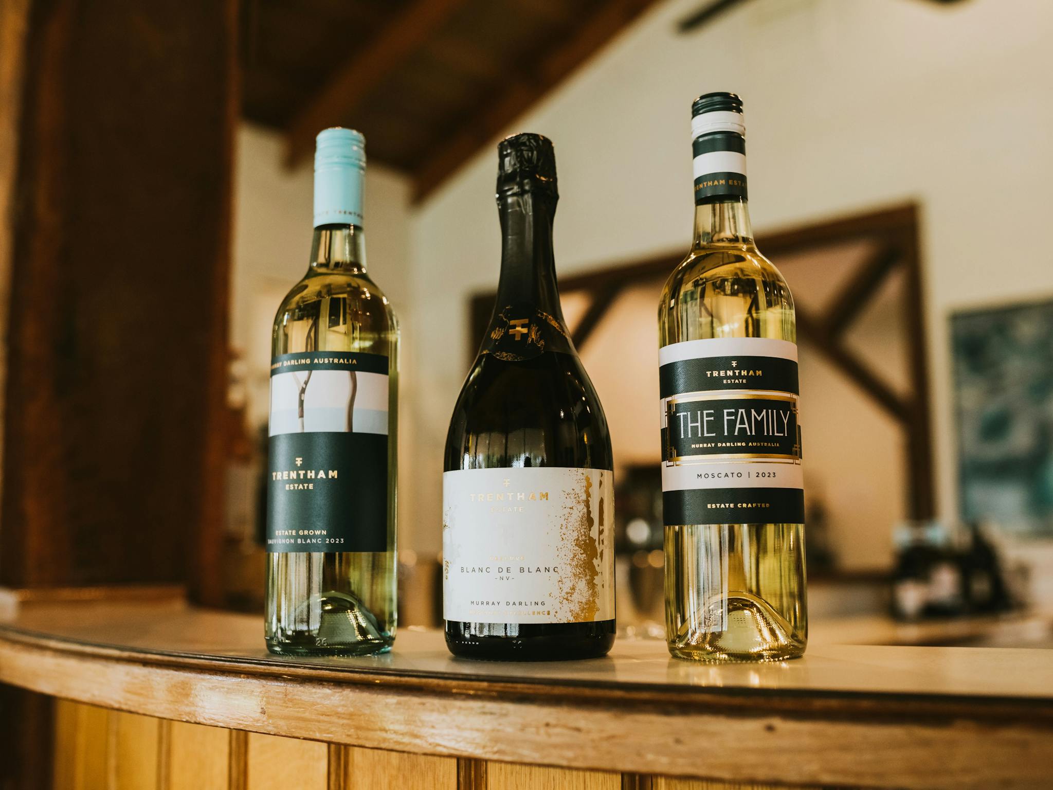 Three varied Trentham Estate label wines sitting on the tasting bench in the Cellar Door