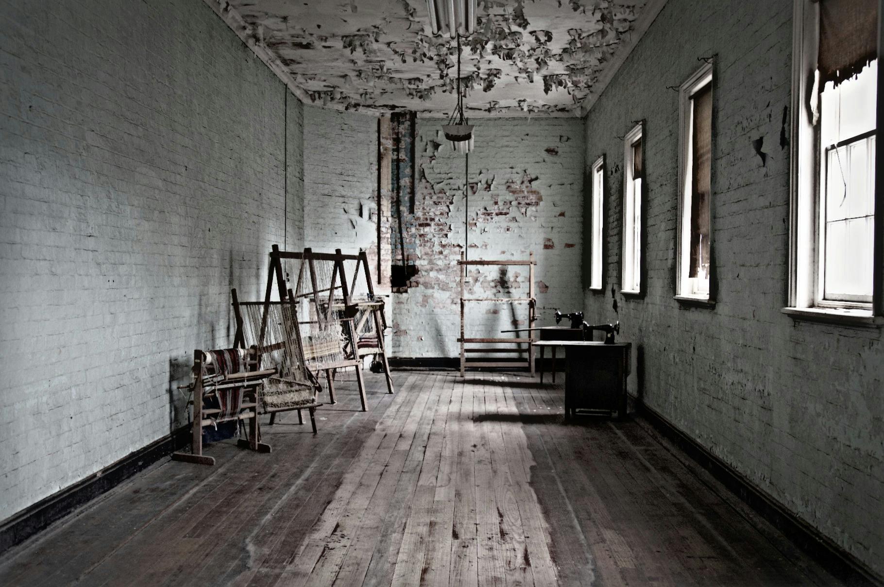 Inside asylum room. Looms and sewing machines visible