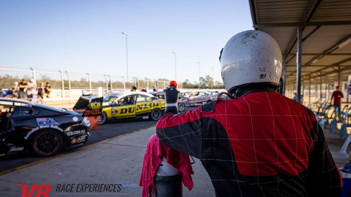 Man looking at cars in pitlane