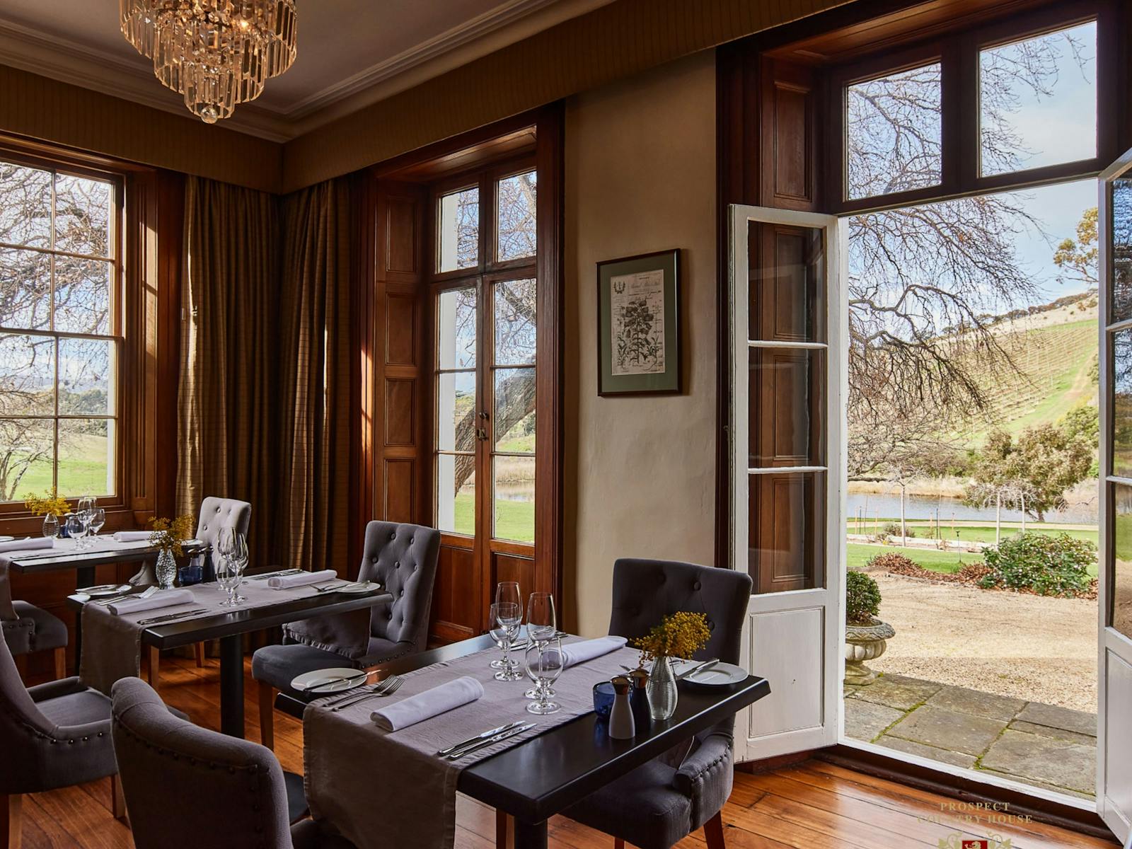 Stunning cedar dining room french doors opening over the Sprawling gardens loverlooking Vineyards
