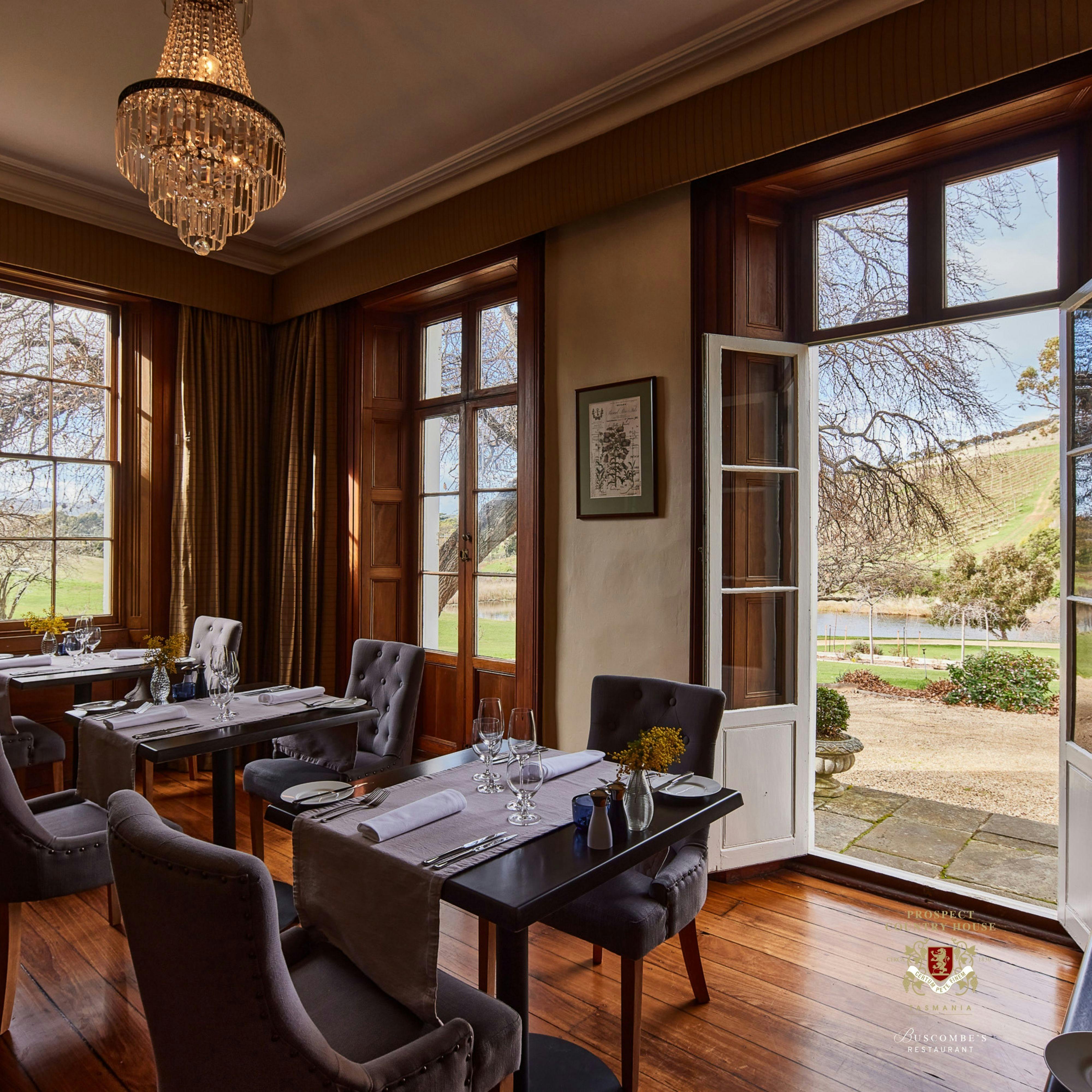 Stunning cedar dining room french doors opening over the Sprawling gardens loverlooking Vineyards