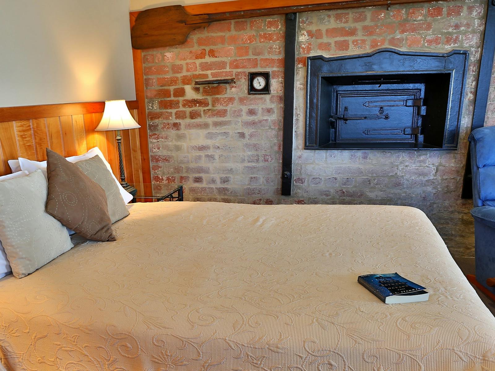The original brick oven on display in the living area, queen bed, comfortable seating