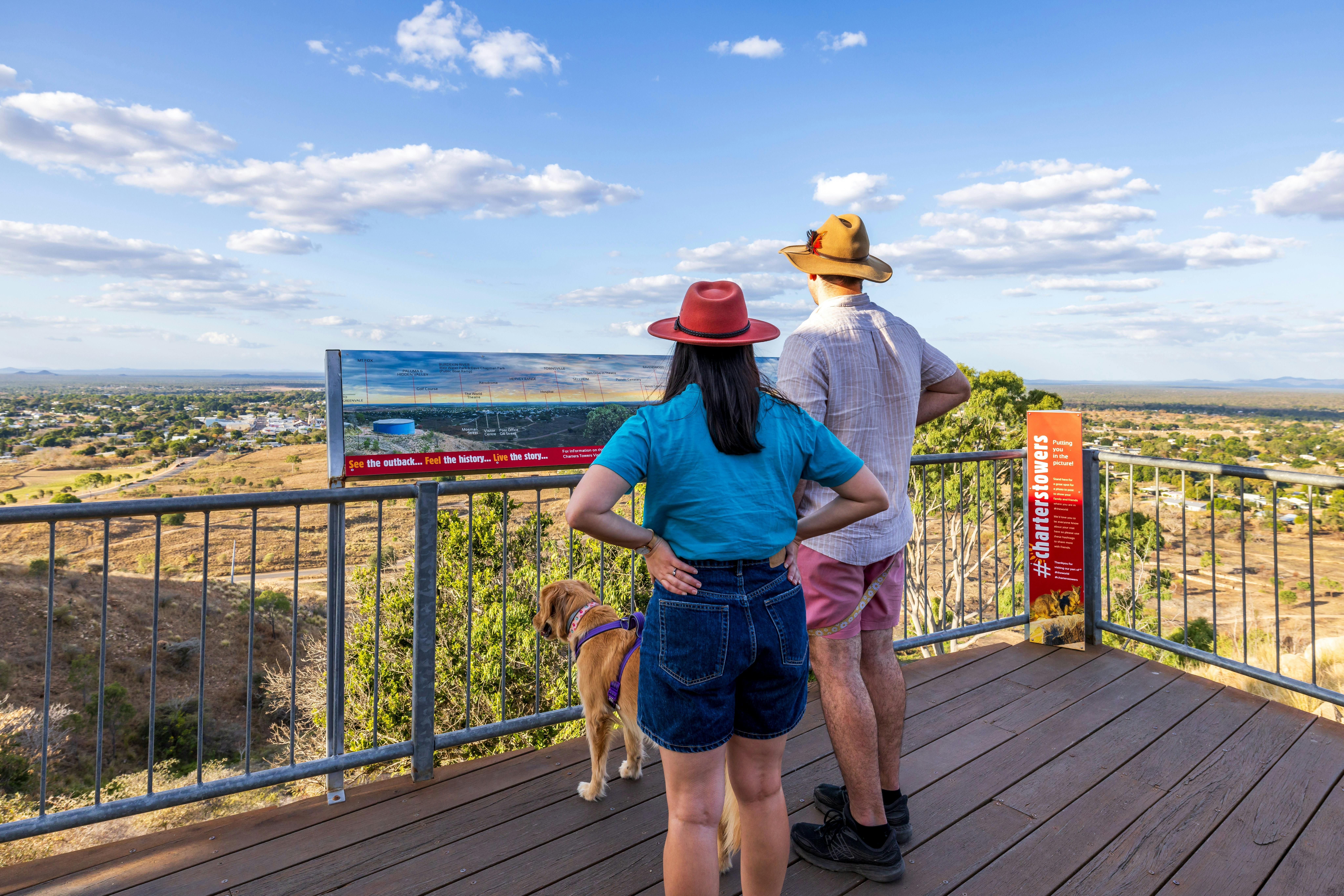 People with dog standing at Towers Hill lookout admiring panoramic views