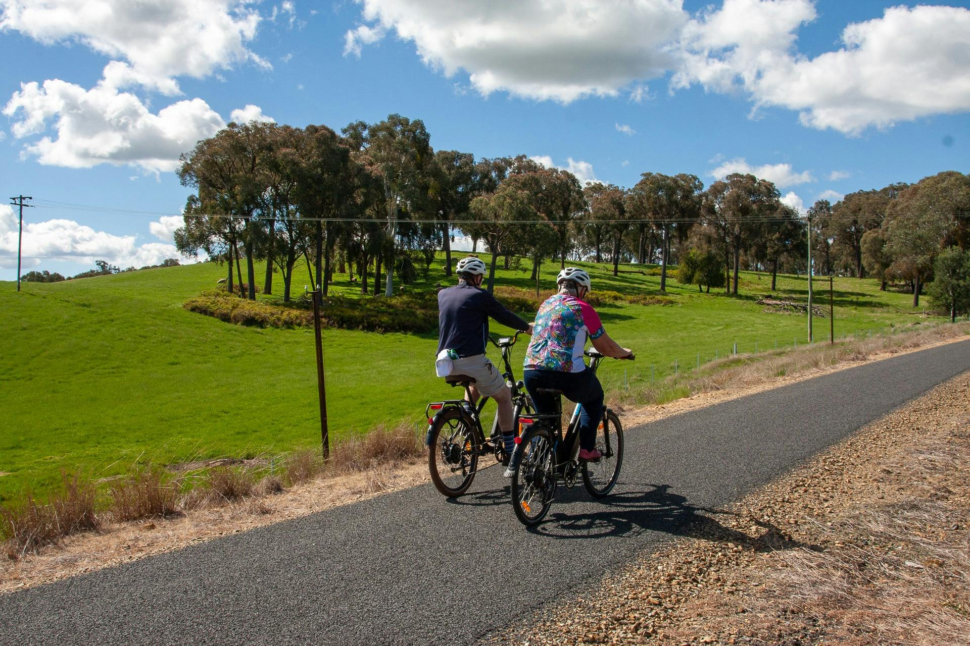 Riders riding uphill on the TUmbarumba Rosewood Rail Trail.