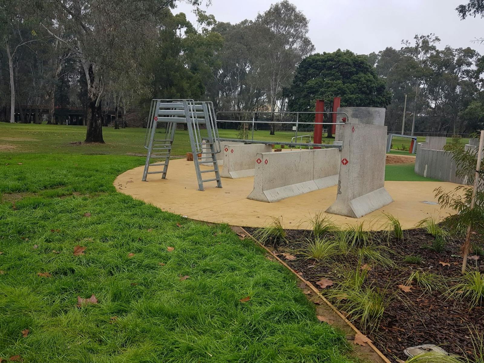 Garden bed, grass, cement blocks, double ladder, parkland, trees