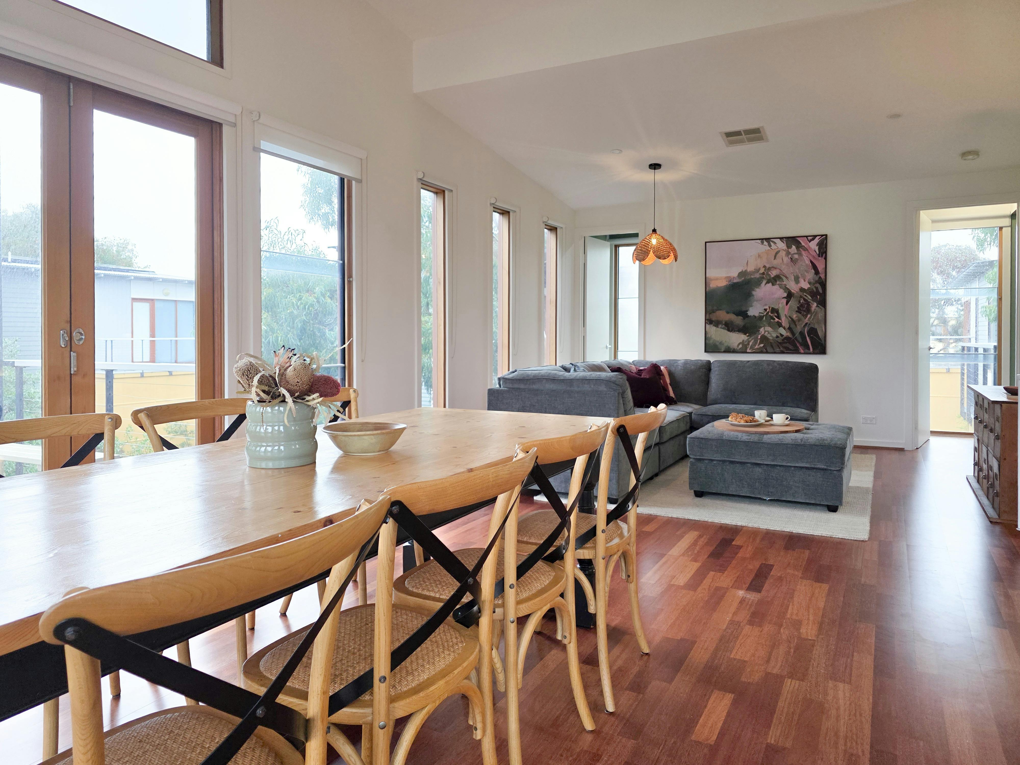 Open-plan dining and lounge with tree top views at Villa 1 by The Shoresack to this