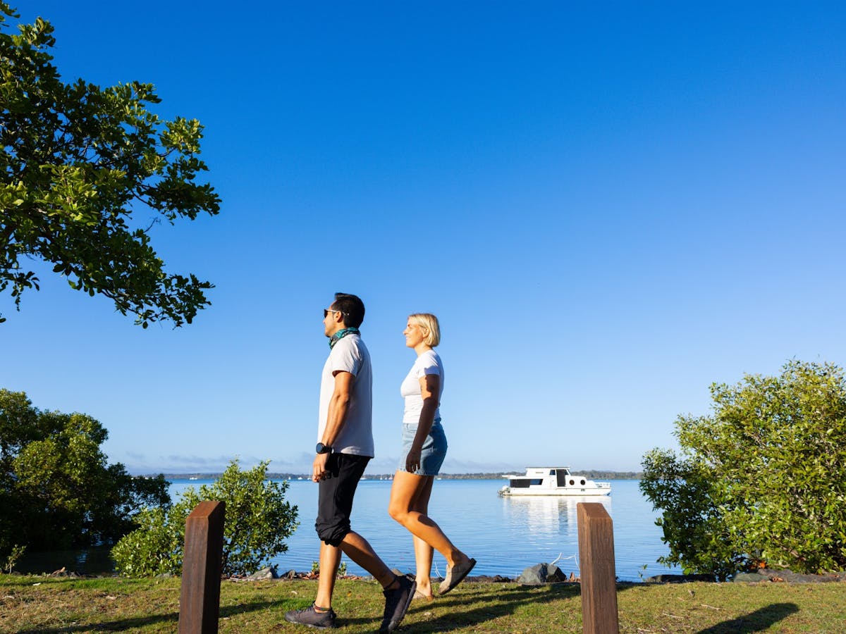 Couple walking alongside the ocean