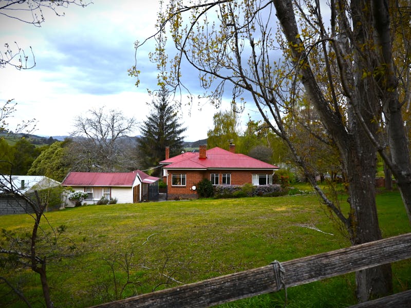 View of the house amoung trees overlooking a valley