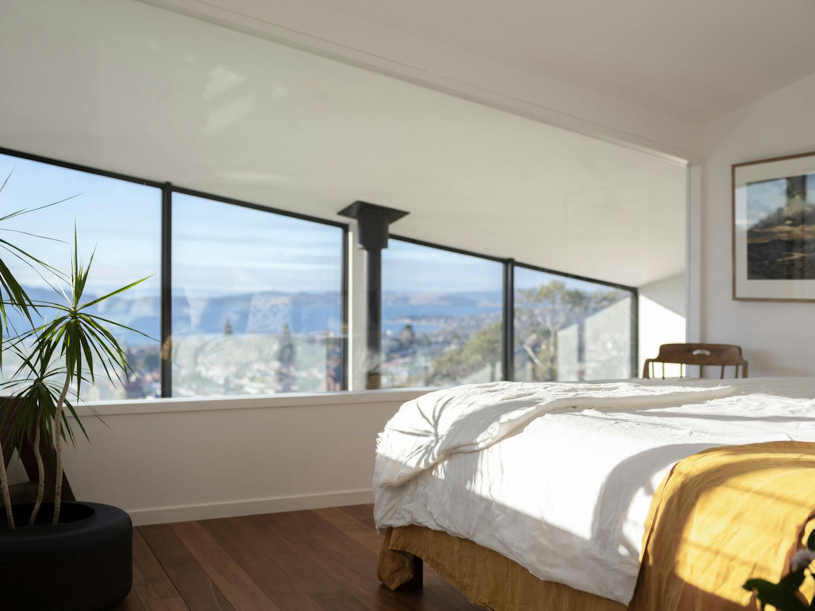 A luxurious king bedroom with incredible sunrises and views of the city below.