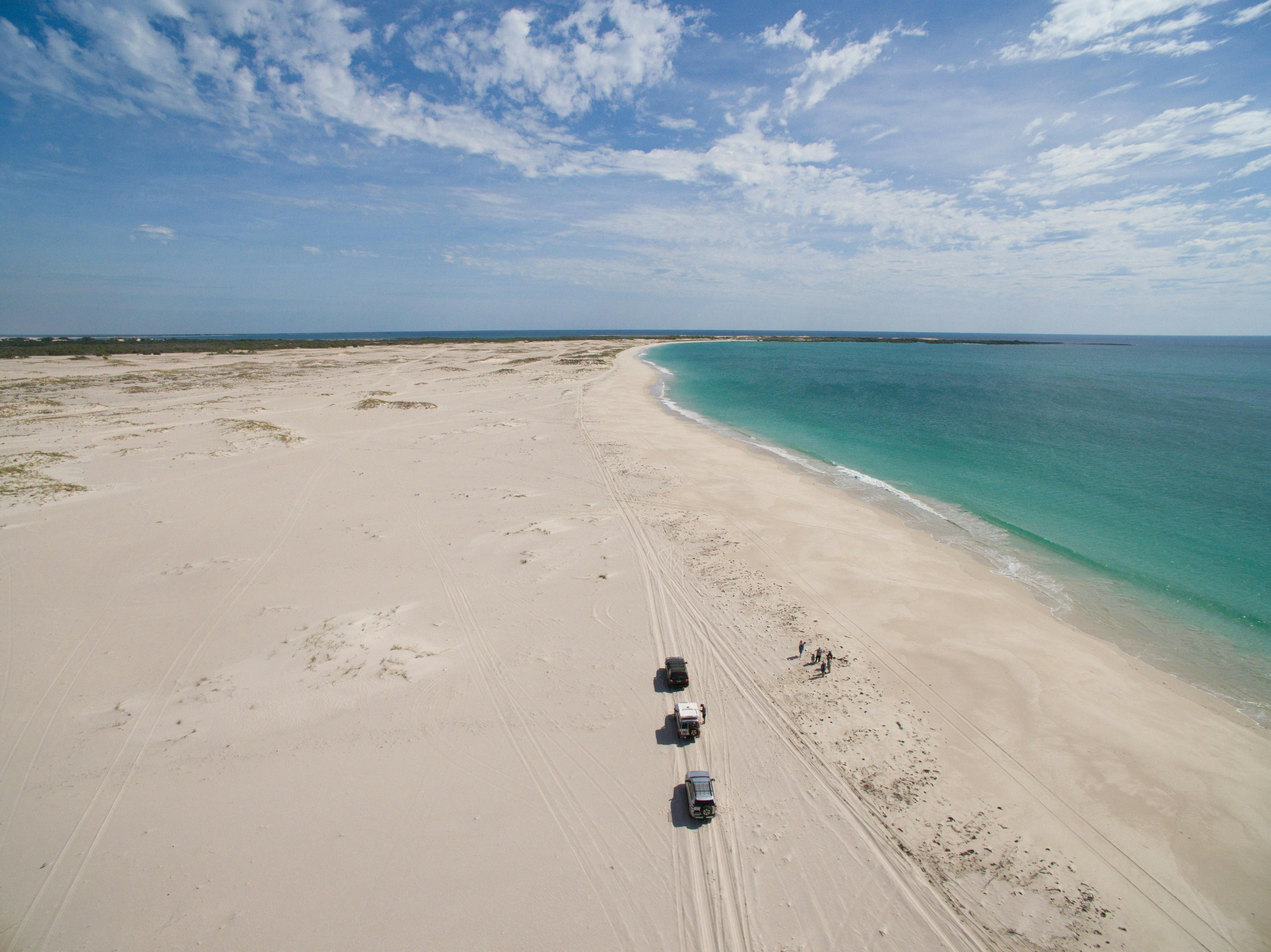 4WD driving along the beach.