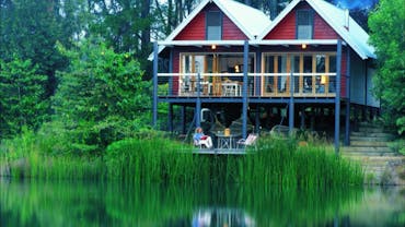 The Boathouse is a contemporary open plan pole building located right on the lake with bifold walls