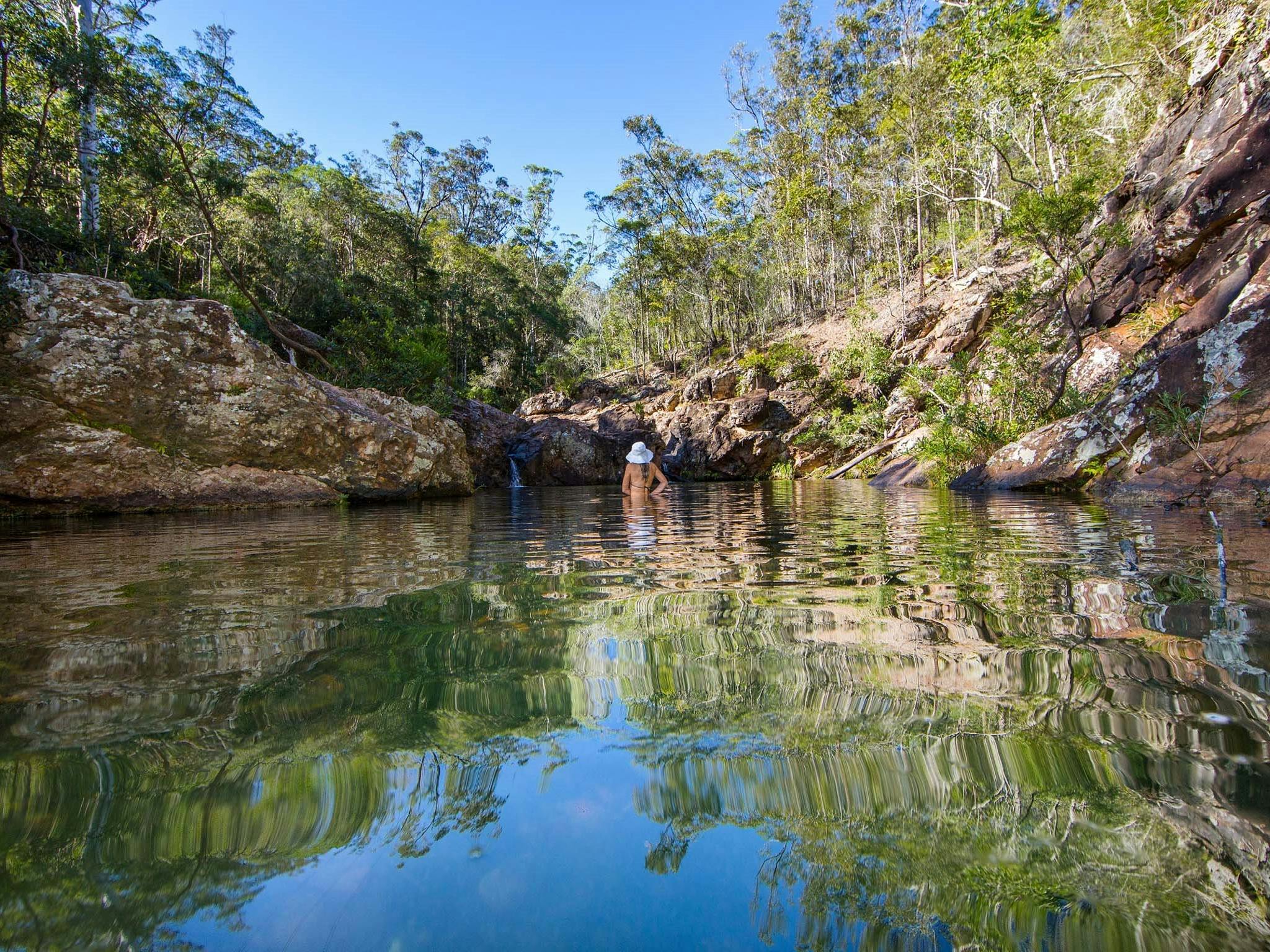 Woman swimming in Rocky Hole and enjoying the scenery Woman swimming in Rocky Hole and enjoying the scenery