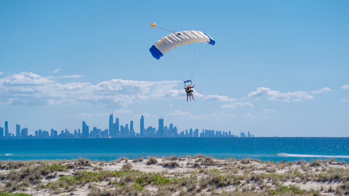 Tandem landing with city skyline