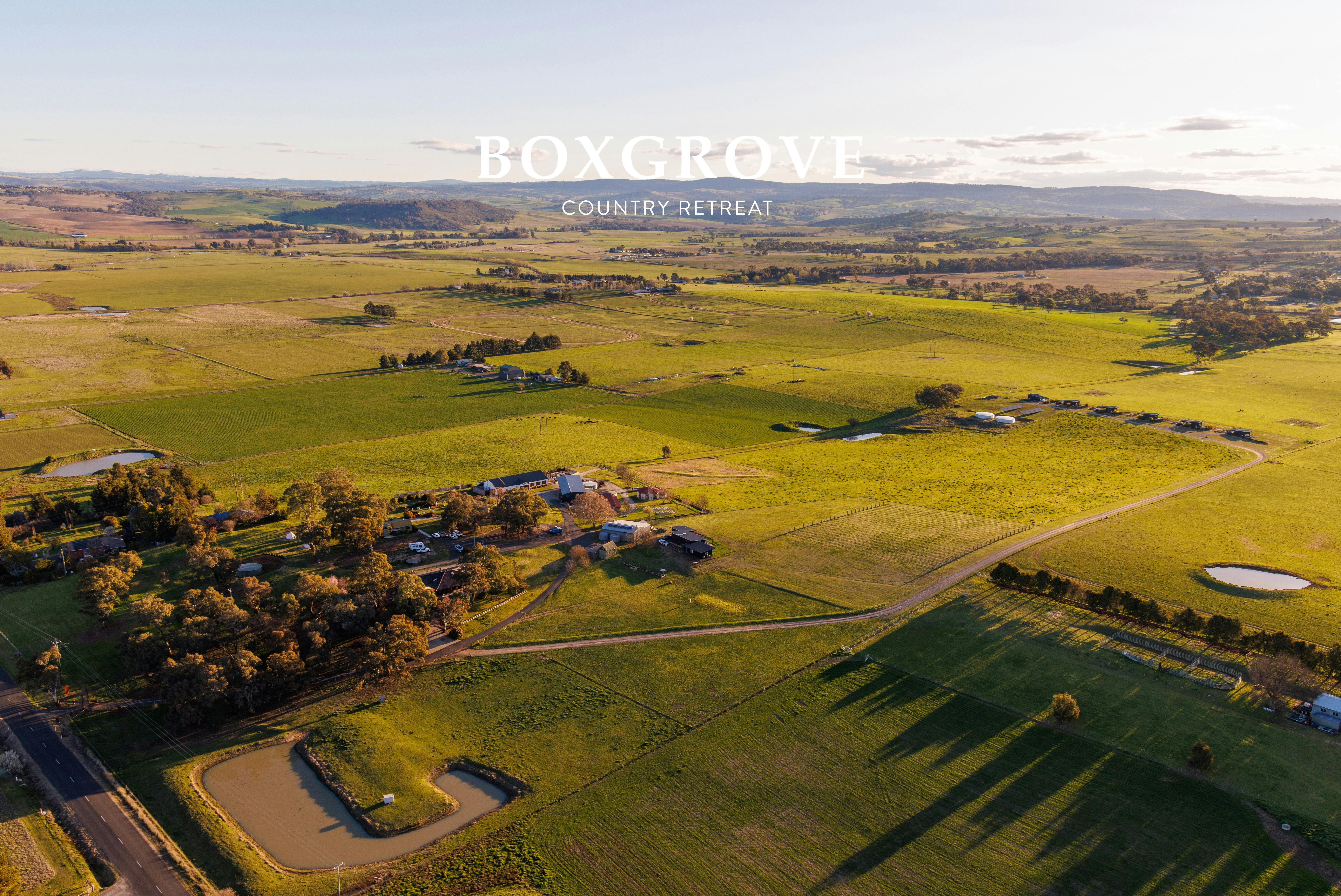 Aerial shot of a farm with a function centre, farm stay cabins, luxury off-grid studios and paddocks