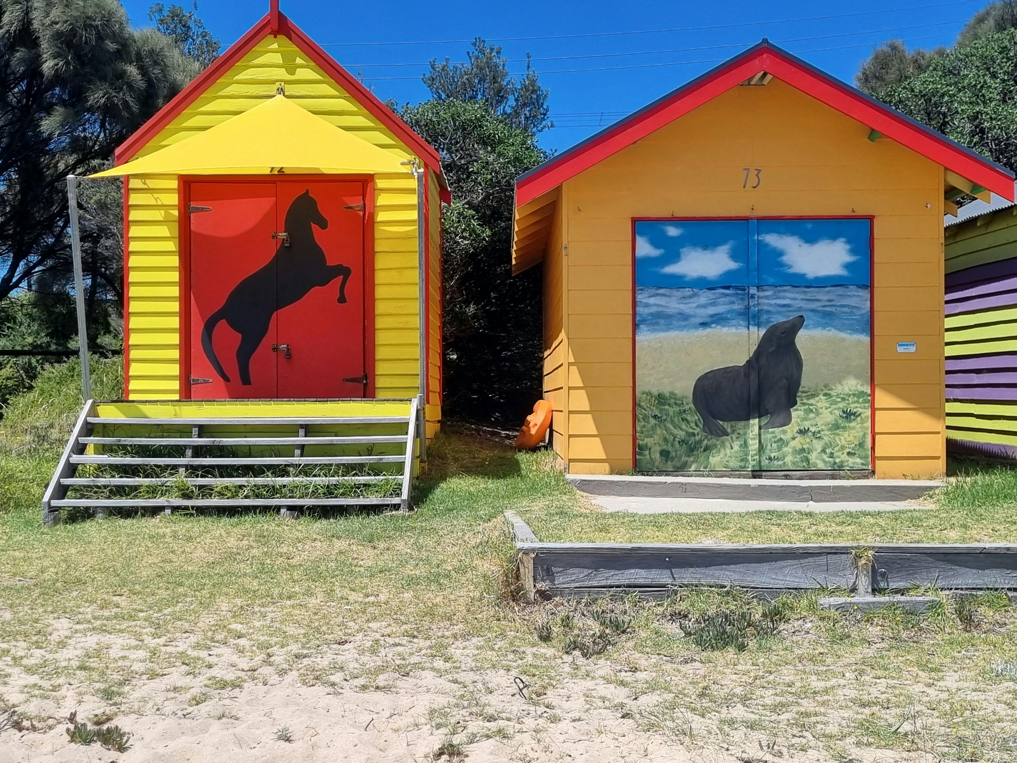 Colourful and artistic beach boxes can be found to view along the bay.
