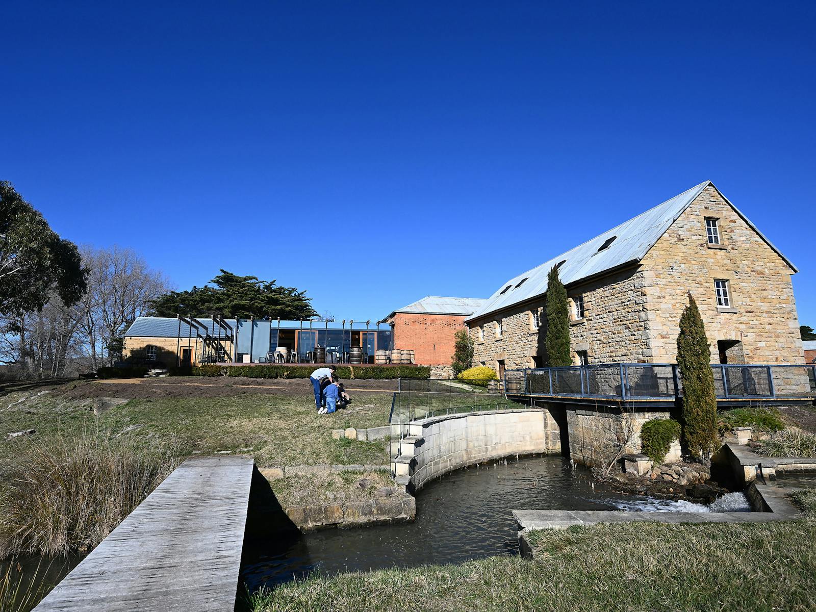 Wide view of Clyde Mill Distillery beside the water channel.