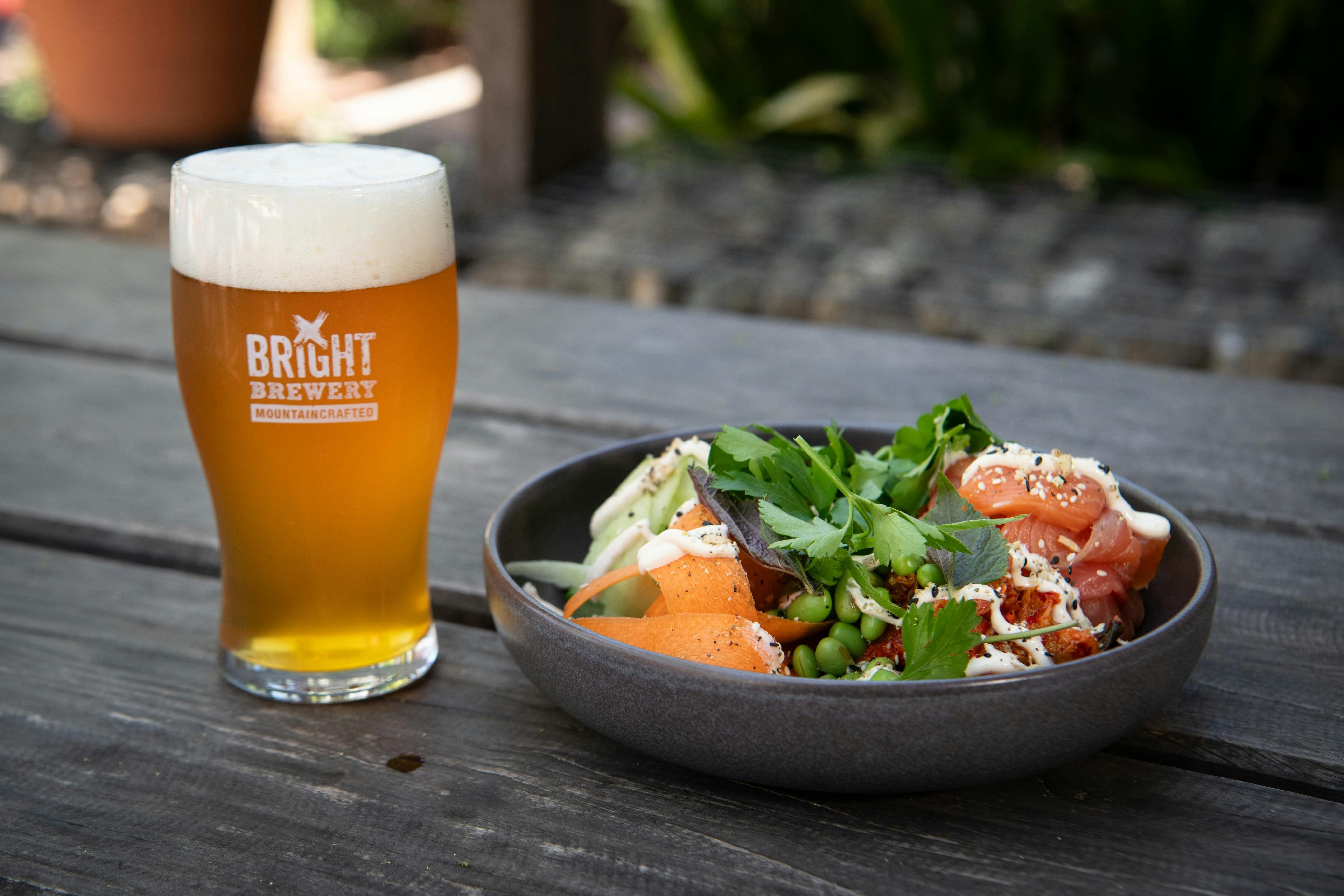 A glass of Bright Brewery beer with a nourishing bowl of food