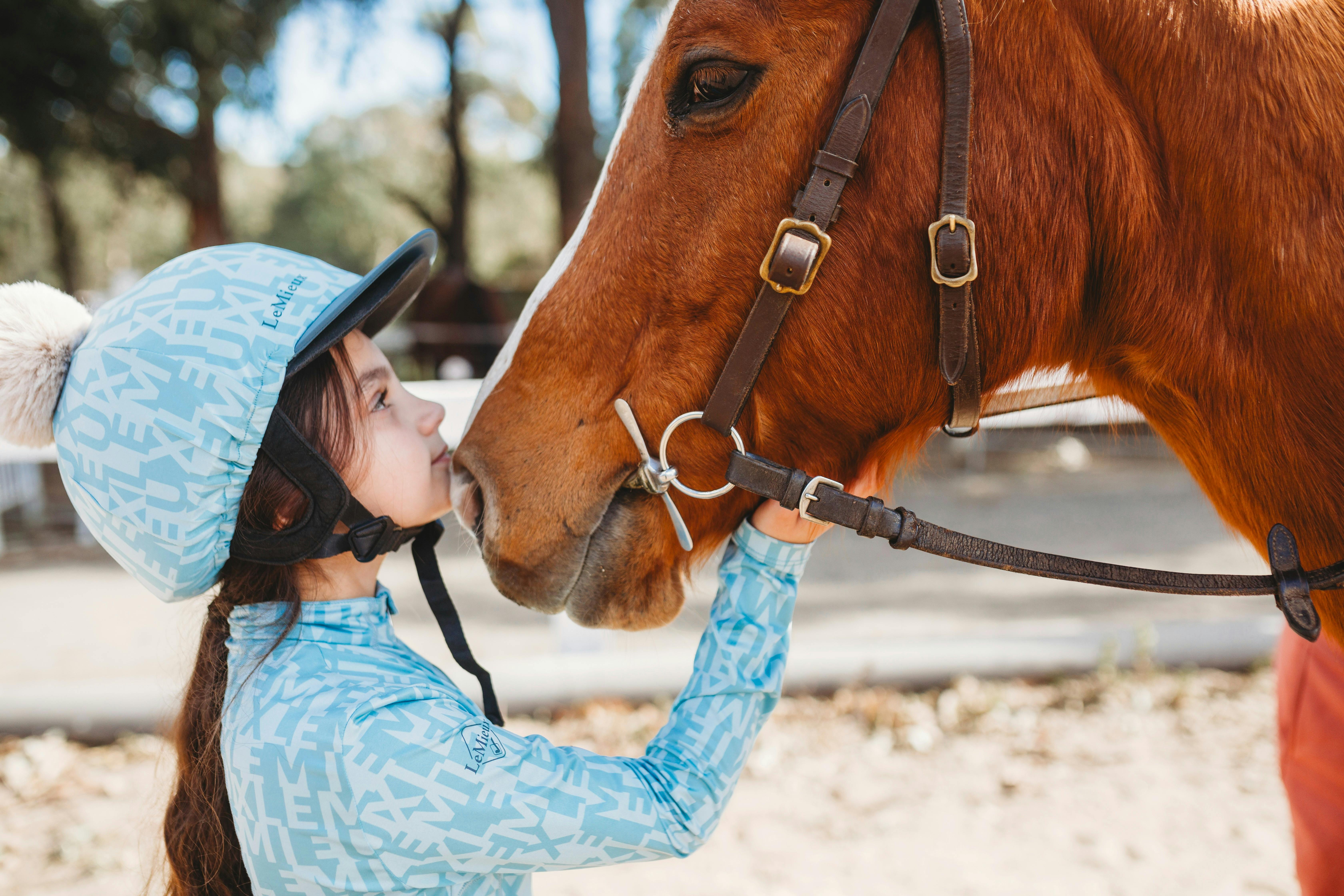 Girl and horse having a moment.
