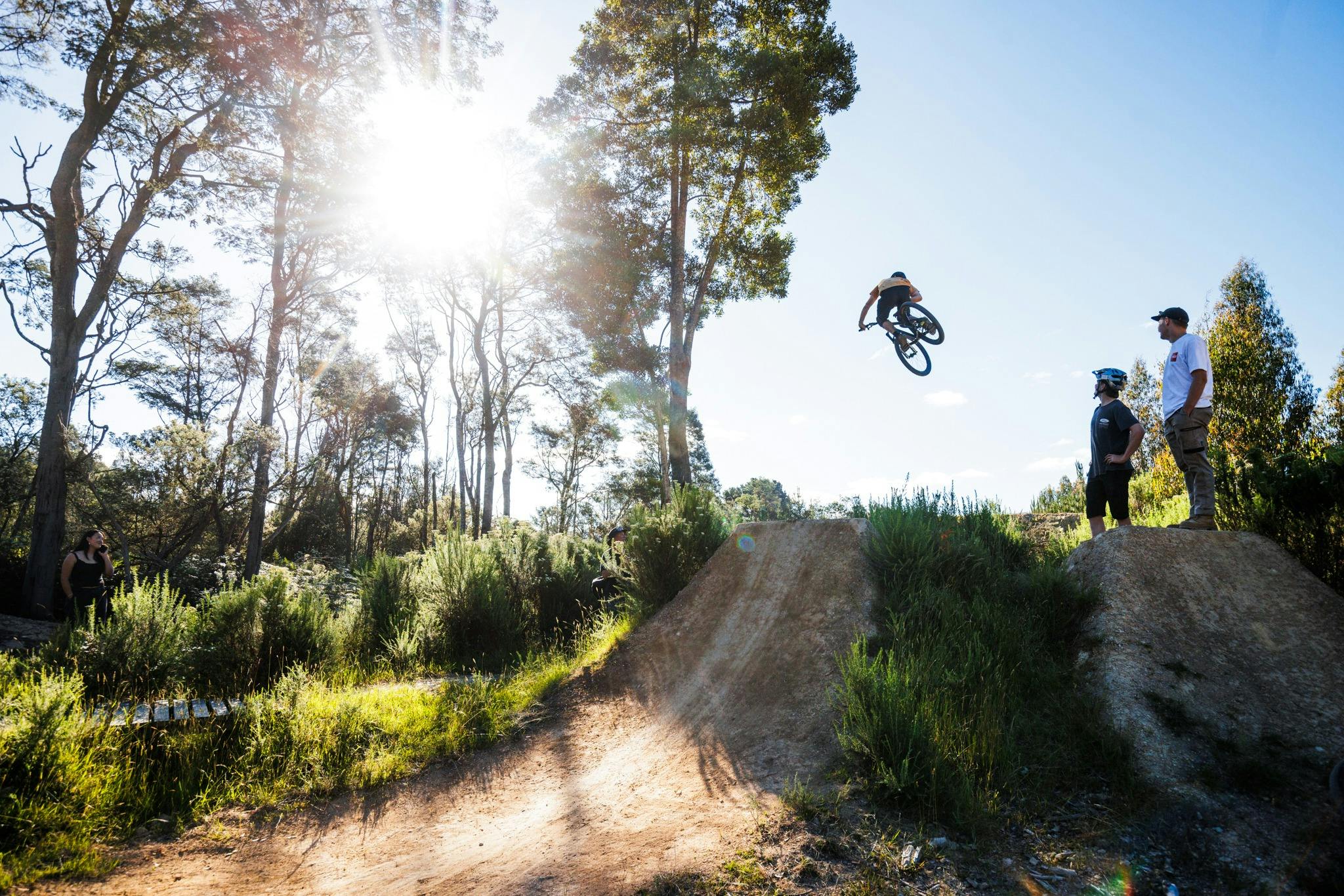 Rider jumping on dirt jumps at maydena bike park