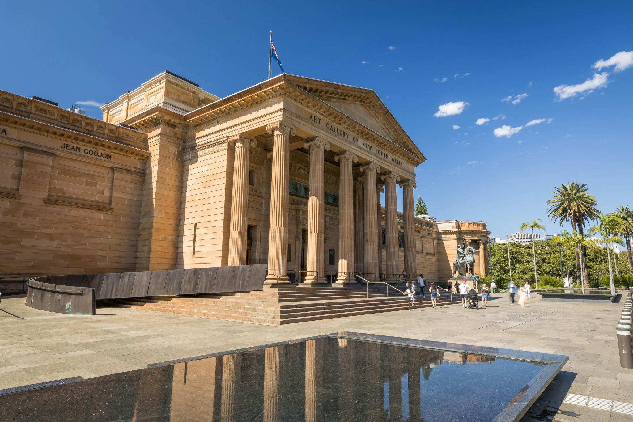 Sandstone columned building with blue sky background