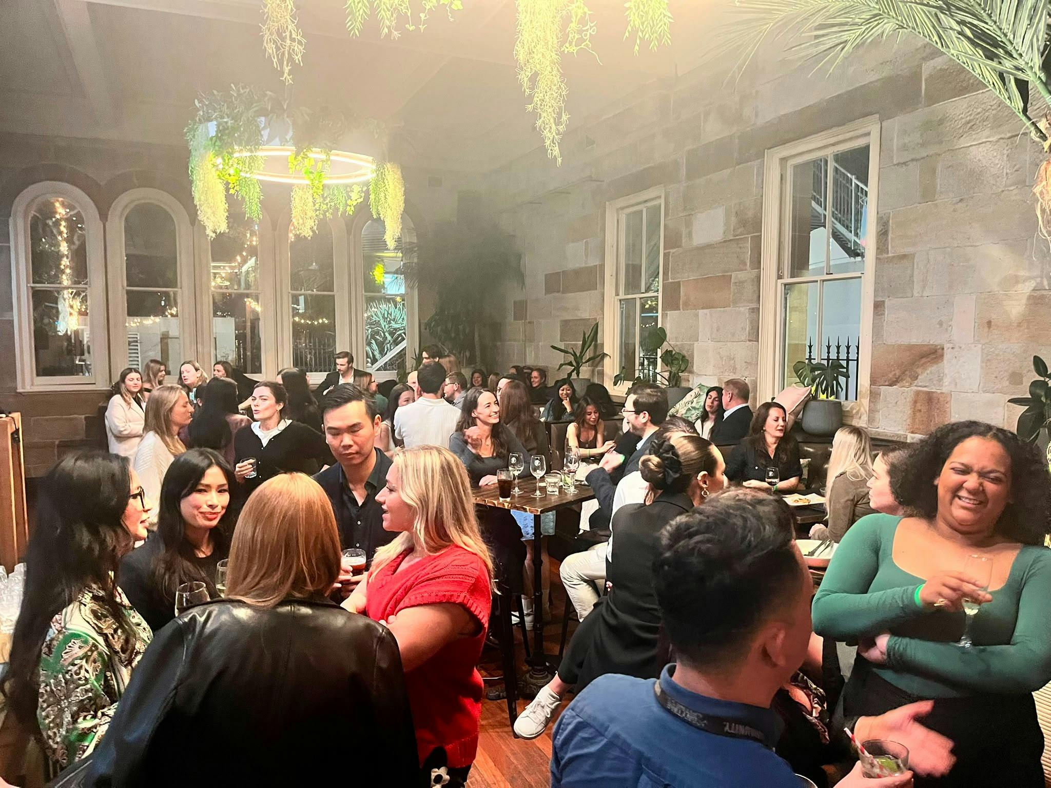 Guests mingling with drinks at a Date My Mate night in the sandstone Greenwood Hotel, North Sydney