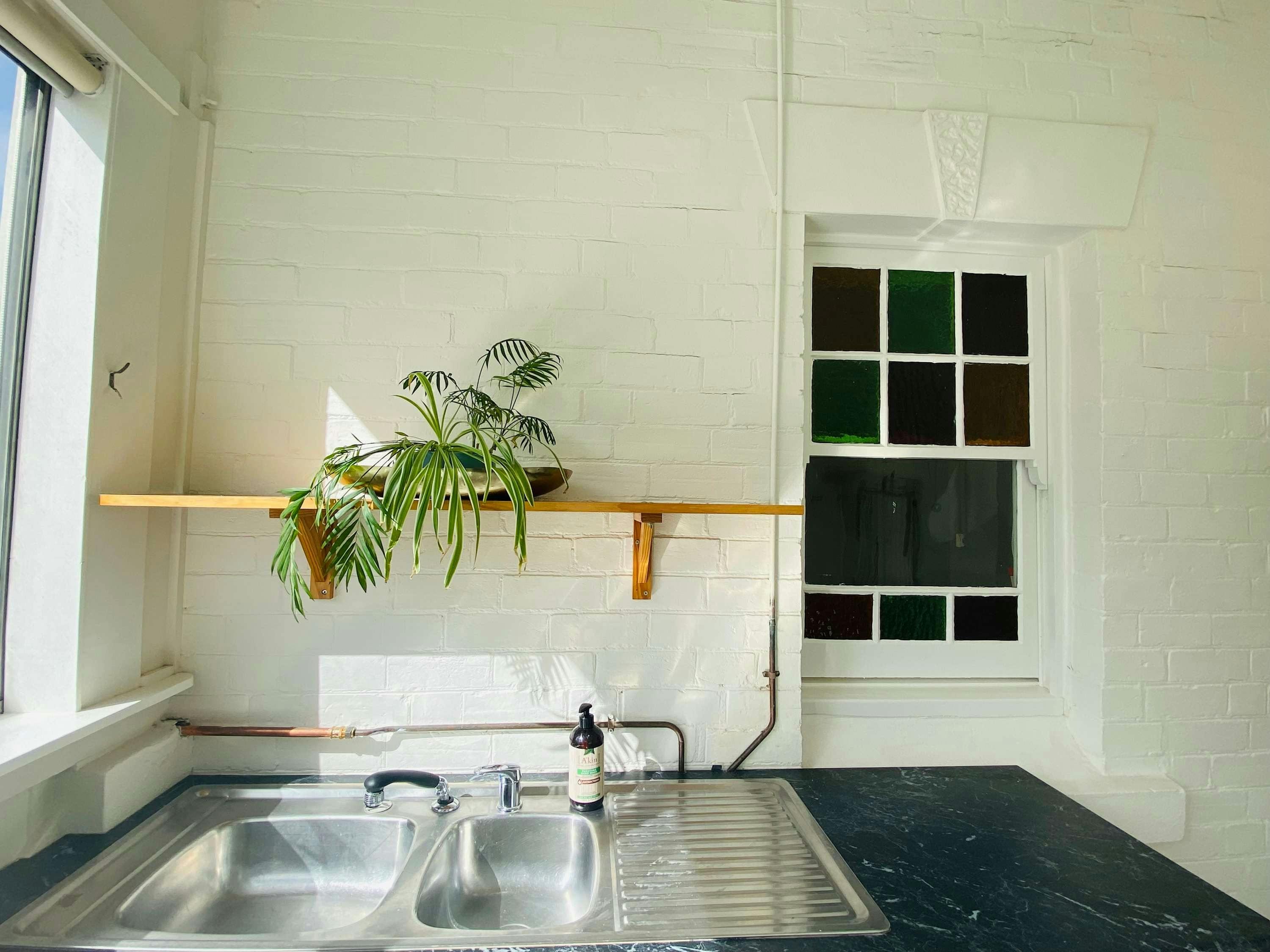 Stainless steel sink, wooden shelf and bench at rankin st