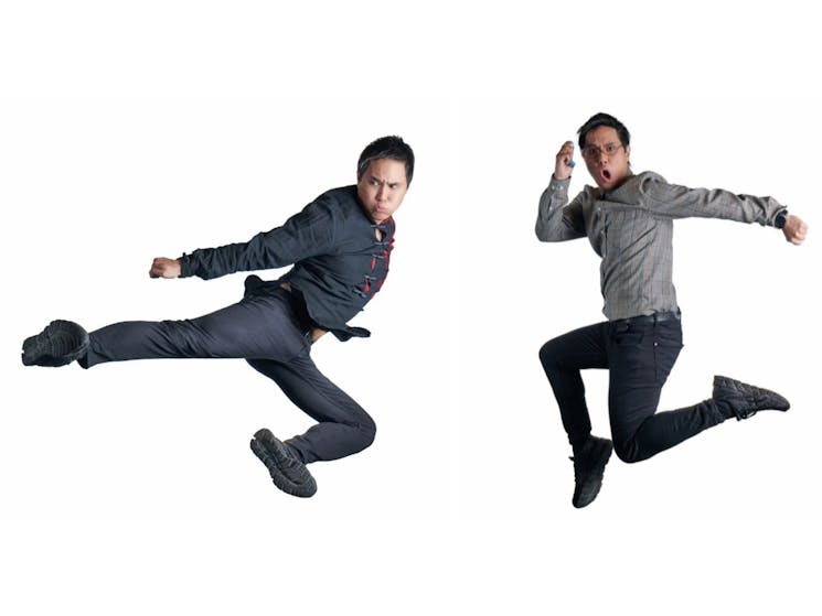 The two performers jump in the air throwing karate moves