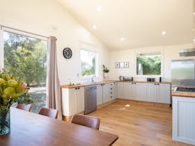 dining table with flowers and kitchen