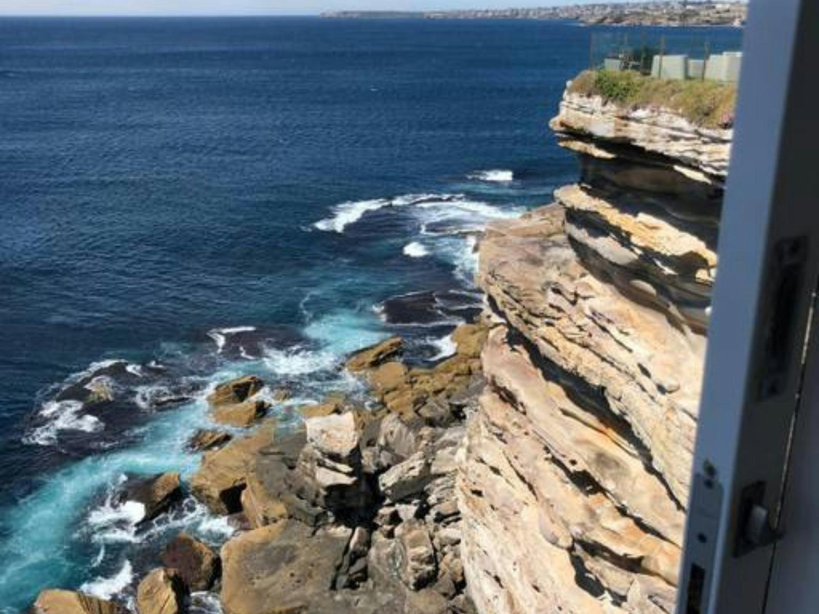 Cliffside apartment with breathtaking views of the ocean and rocky coastline.