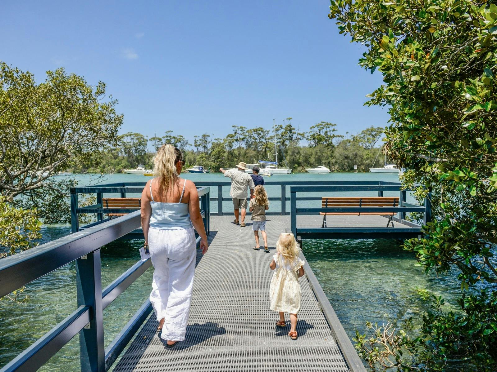 Family walking along the Mangrove Board walk in Huskisson