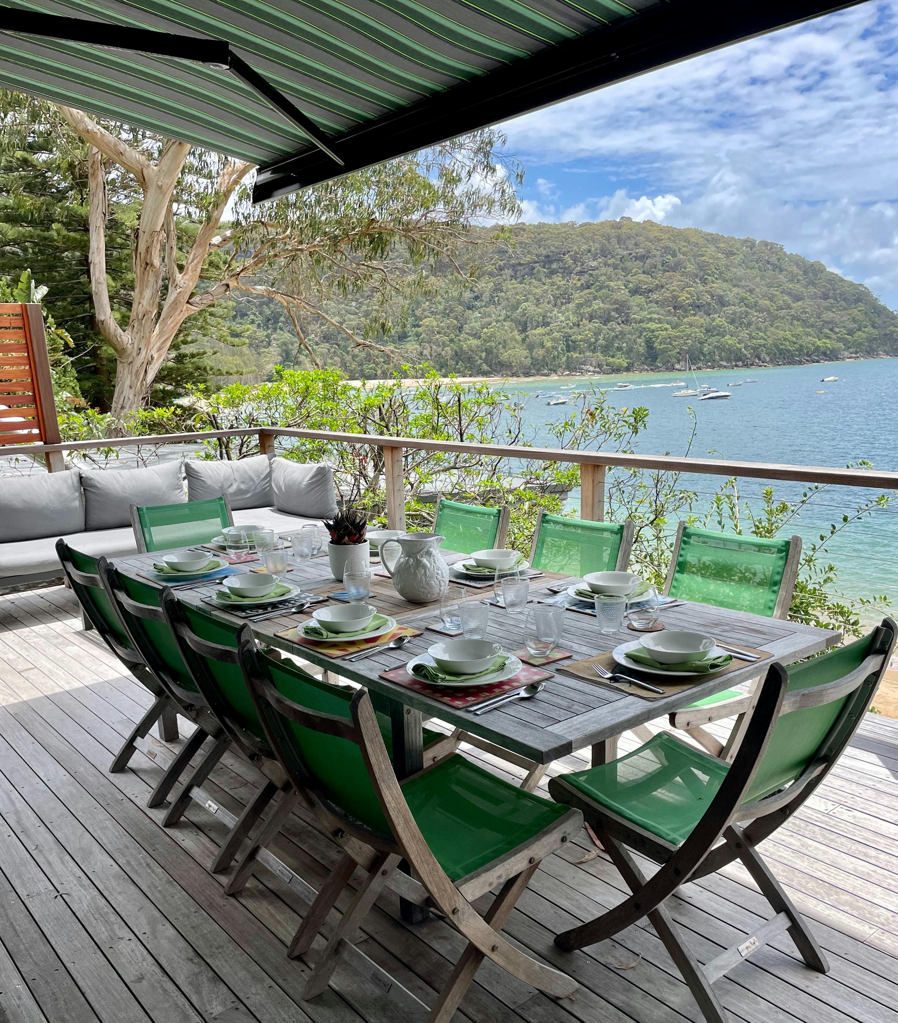a set table on a deck with fabulous views