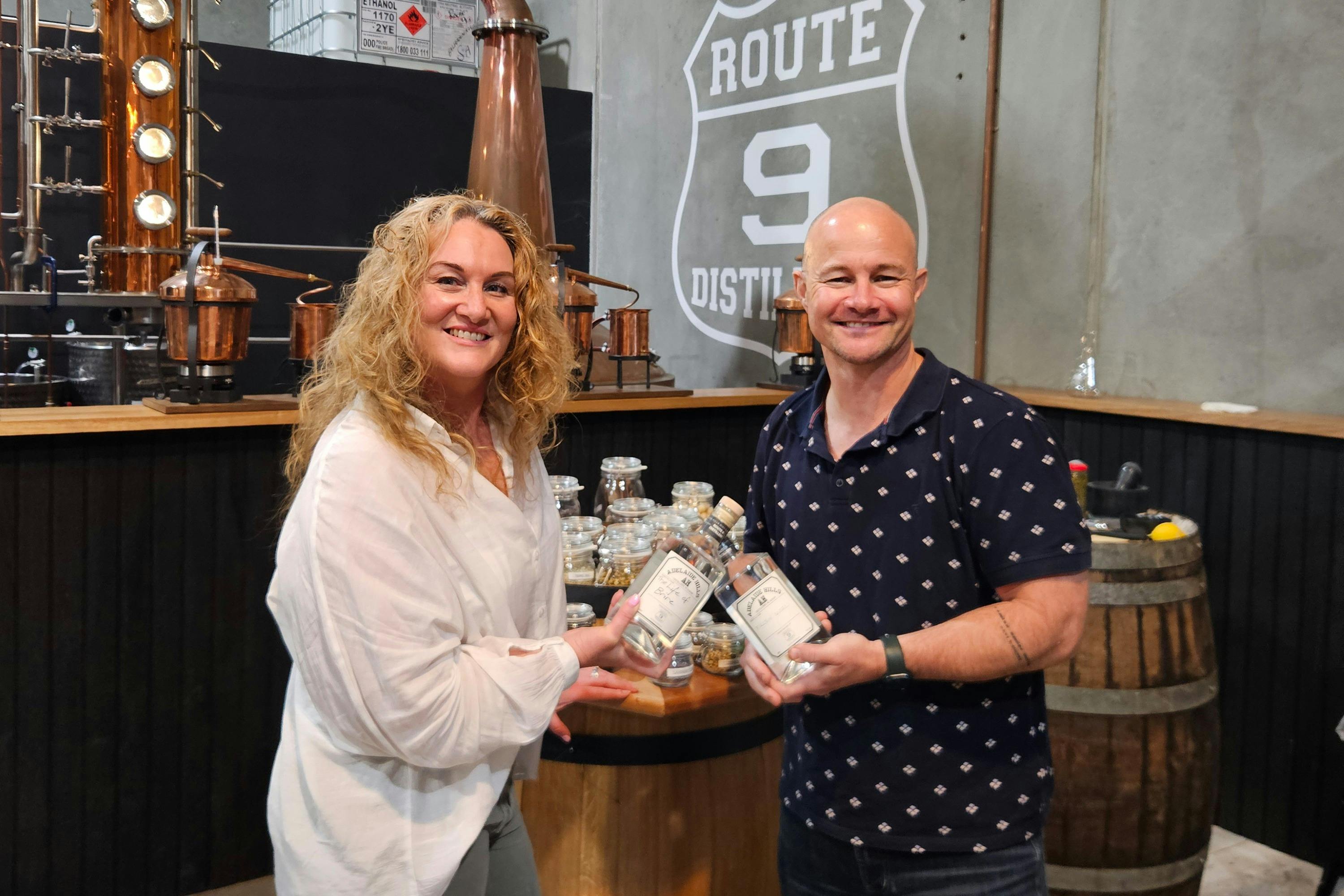 People holding a bottle of gin