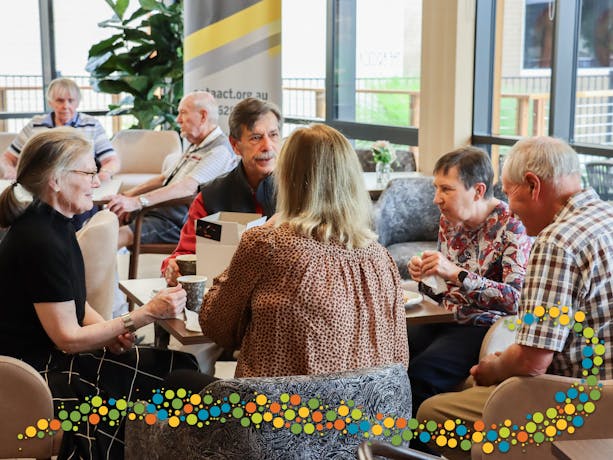 Seniors sitting around a table talking