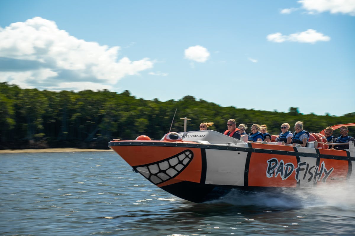 Guest on Bad Fishy Jet Boat Smiling as they speed by in Cairns Tropical North Queensland