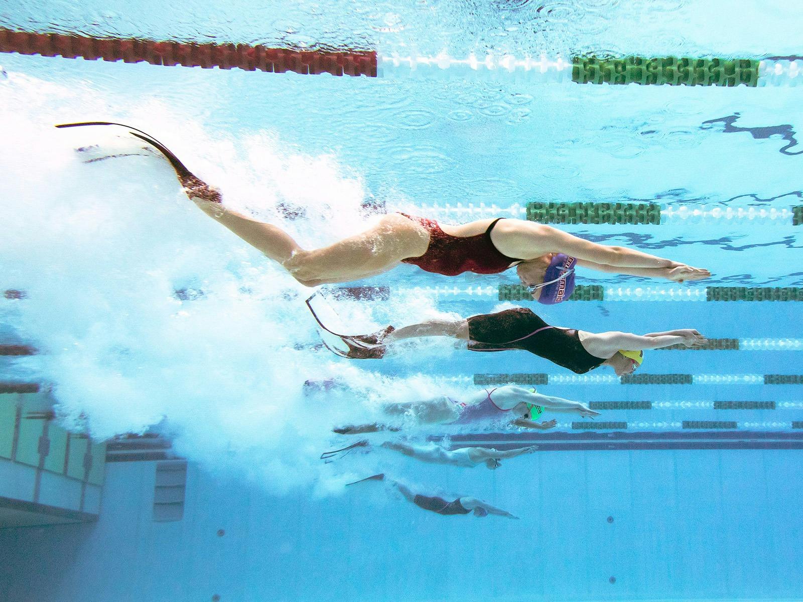 Pool rescue athletes dive in the pool to start a race