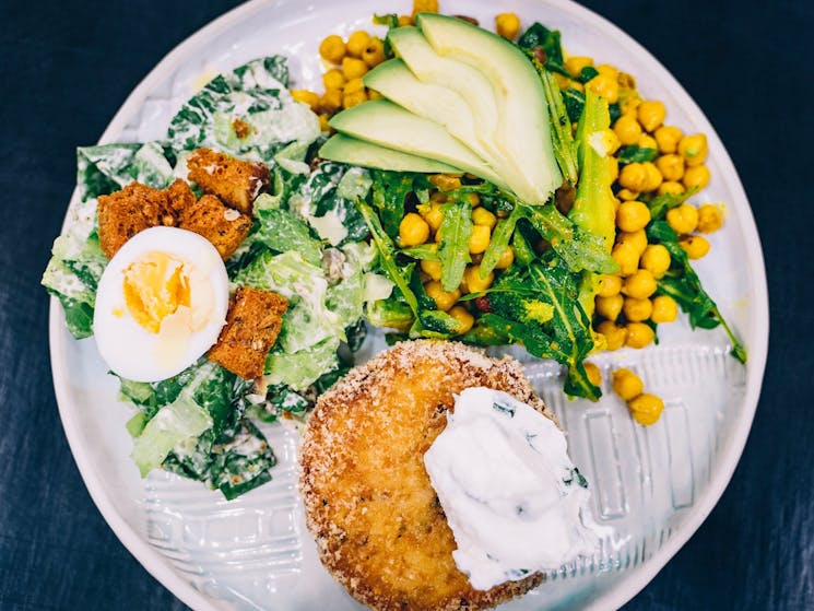 A vegetarian pattie with salad on a plate